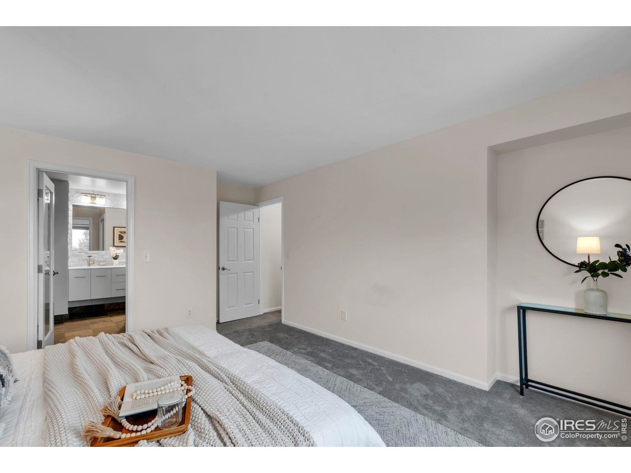 4636 Devonshire Street Boulder, CO 80301 - Photo 19 of 40 a bedroom with a bed and a mirror
