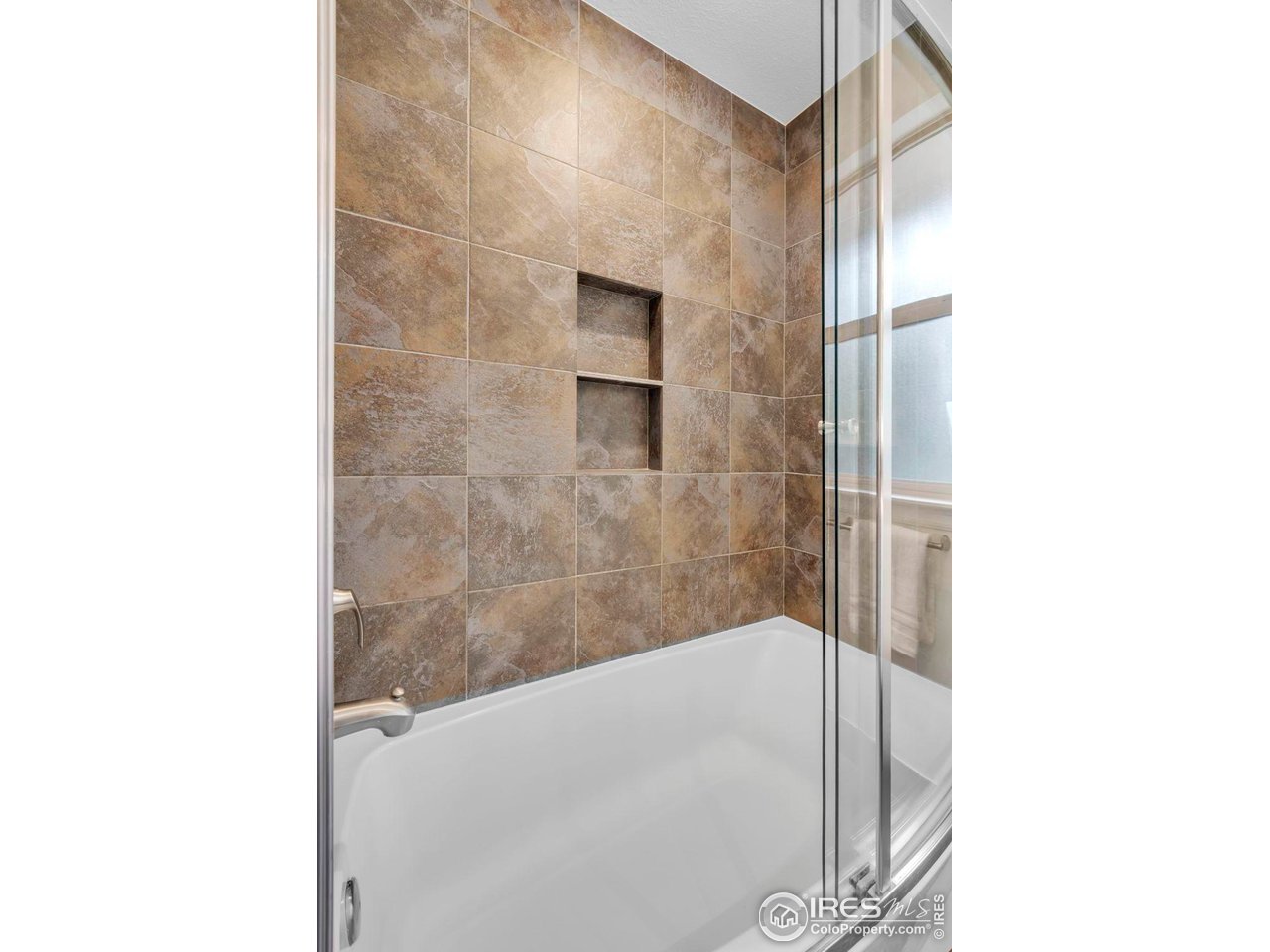 4636 Devonshire Street Boulder, CO 80301 - Photo 24 of 40 a bathroom with a bathtub and a shower