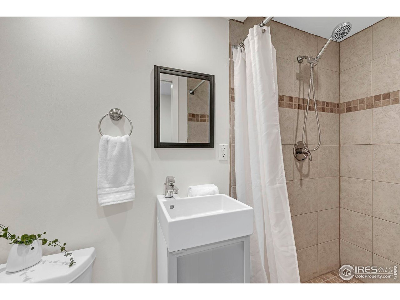 4636 Devonshire Street Boulder, CO 80301 - Photo 29 of 40 a bathroom with a sink a mirror and shower