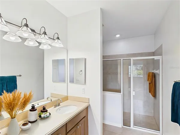 a bathroom with a sink vanity granite and a mirror