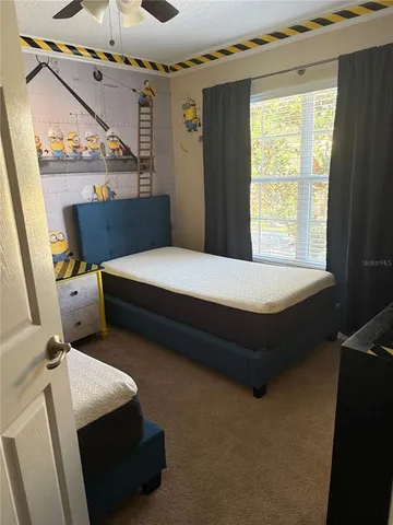 a bedroom with a bed and window