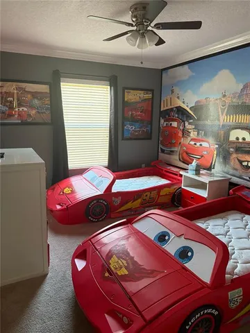 a bedroom with a bed and a lamp on dresser next to a window