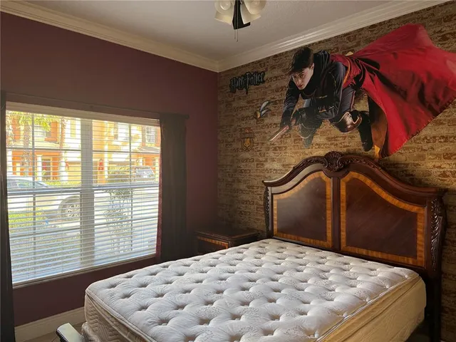 a bedroom with a bed and a window