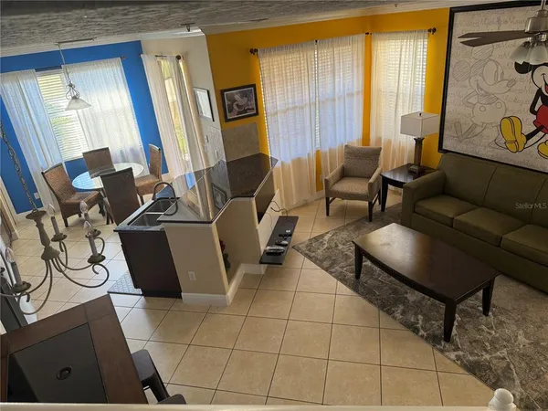 a living room with furniture a window and gym equipment