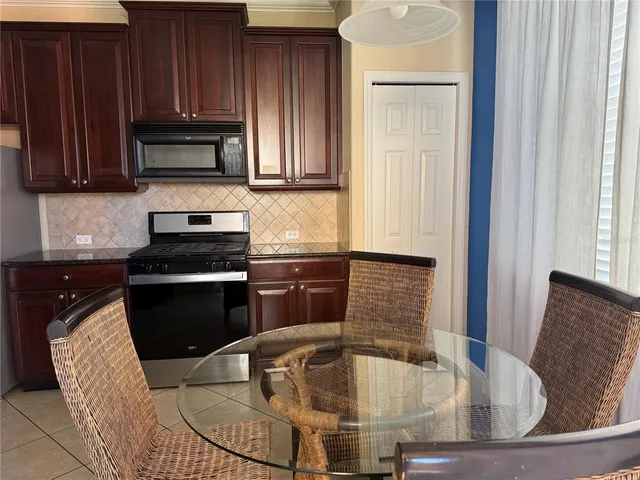 a kitchen with a stove a sink and a microwave