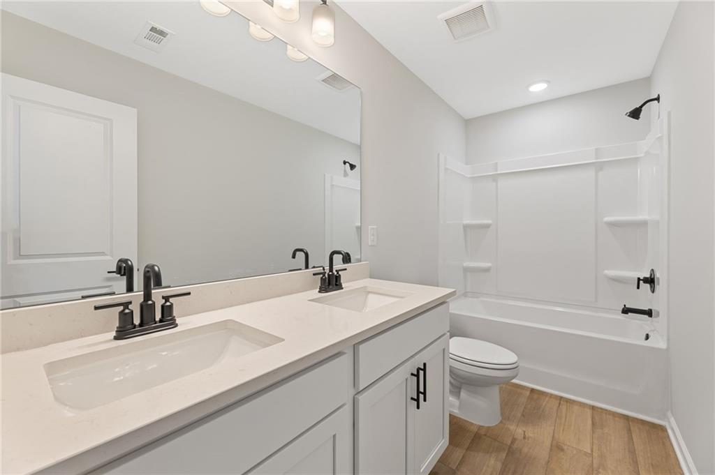 181 Atlas Lane Winder, GA 30680 - Photo 17 of 20 a bathroom with a sink a toilet and a bathtub