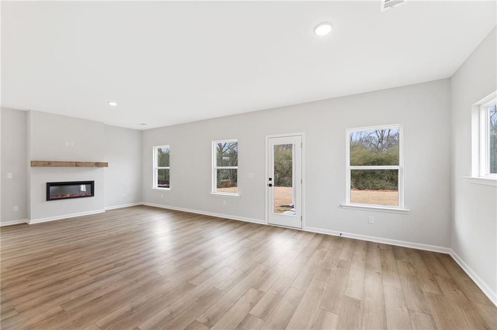 181 Atlas Lane Winder, GA 30680 - Photo 9 of 20 an empty room with wooden floor and windows