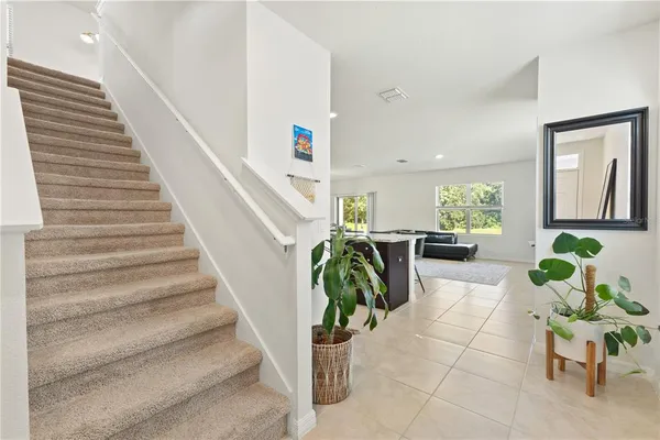 a living room with a couch and a wooden floor
