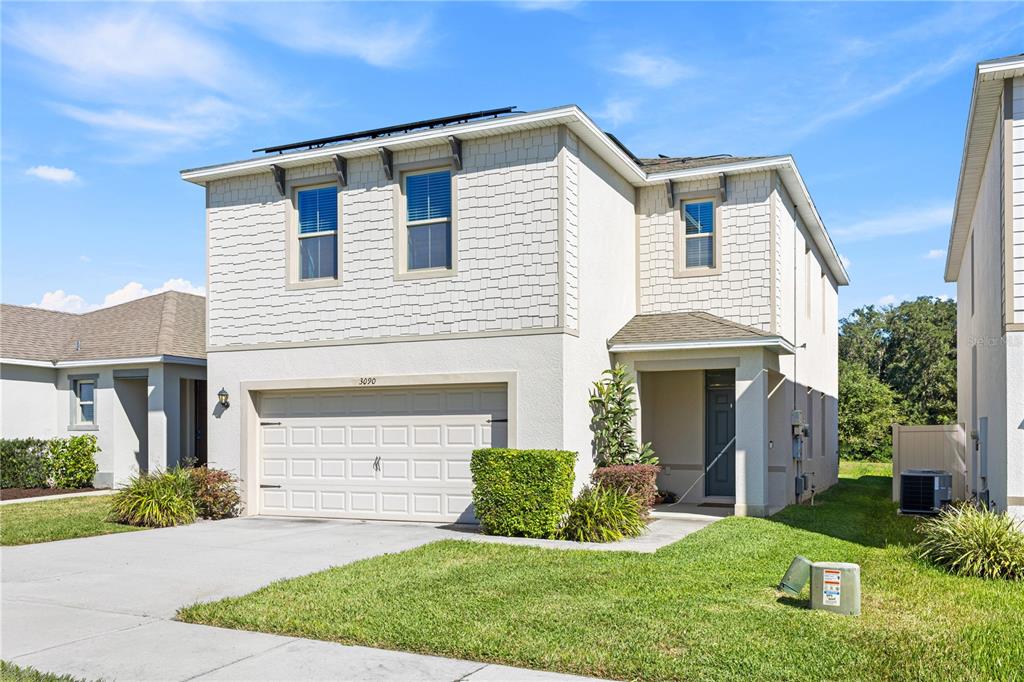 3090 Timber Hawk Circle Ocoee, FL 34761 - Photo 2 of 54 a front view of a house with a yard and garage