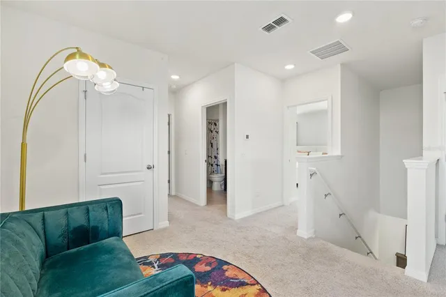 a bedroom with a bed a mirror and a window