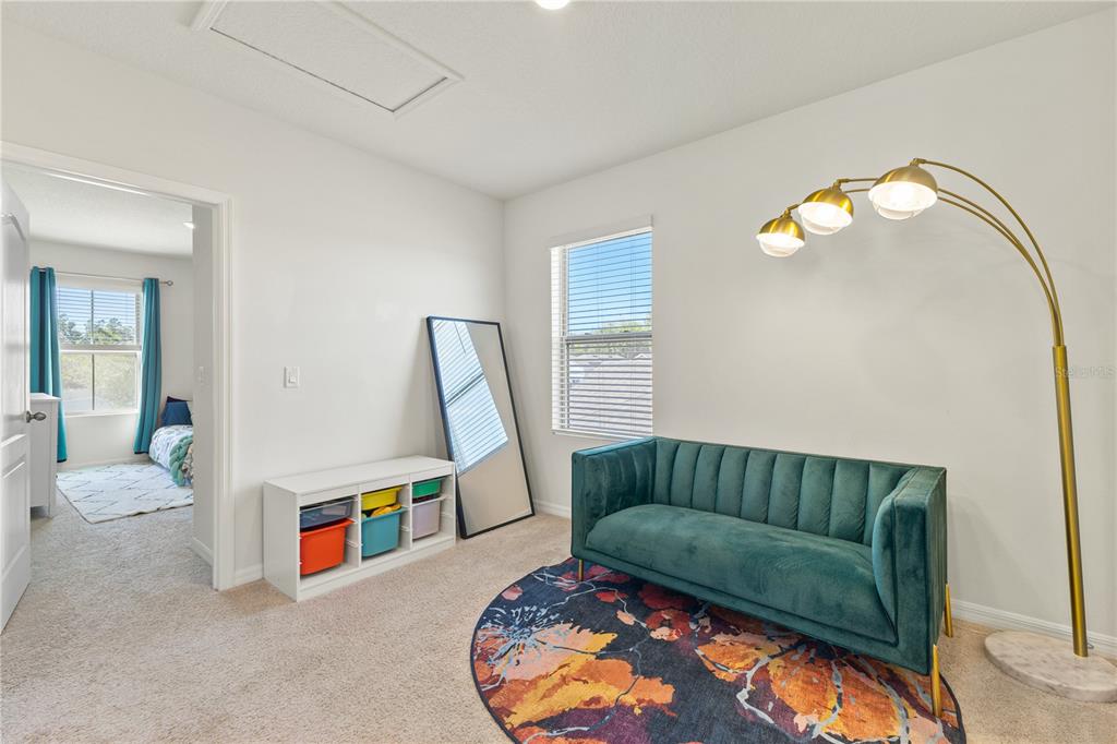 3090 Timber Hawk Circle Ocoee, FL 34761 - Photo 22 of 54 a living room with a couch and a wooden floor