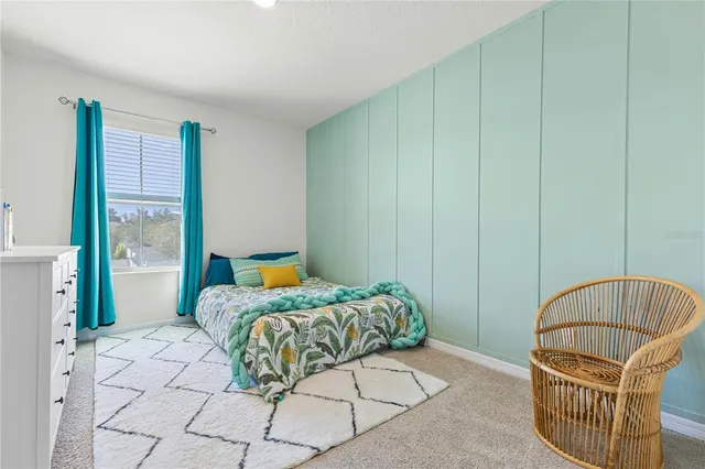 a bedroom with a bed and window