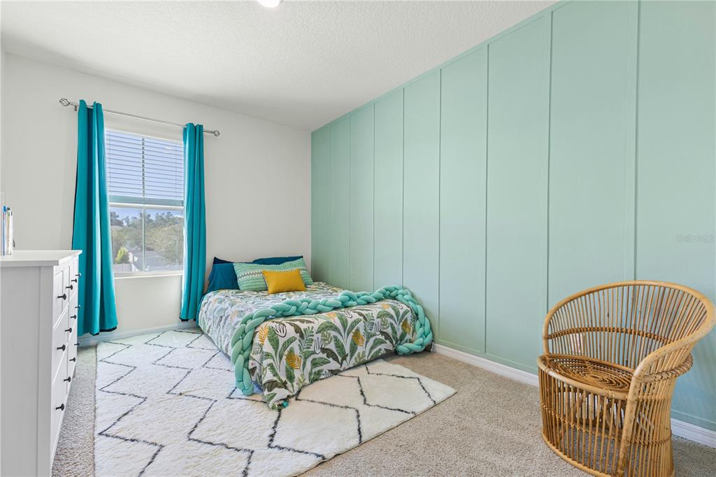 3090 Timber Hawk Circle Ocoee, FL 34761 - Photo 23 of 54 a bedroom with a bed a mirror and a window