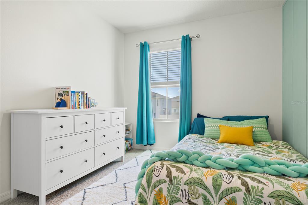 3090 Timber Hawk Circle Ocoee, FL 34761 - Photo 25 of 54 a bedroom with a bed and window