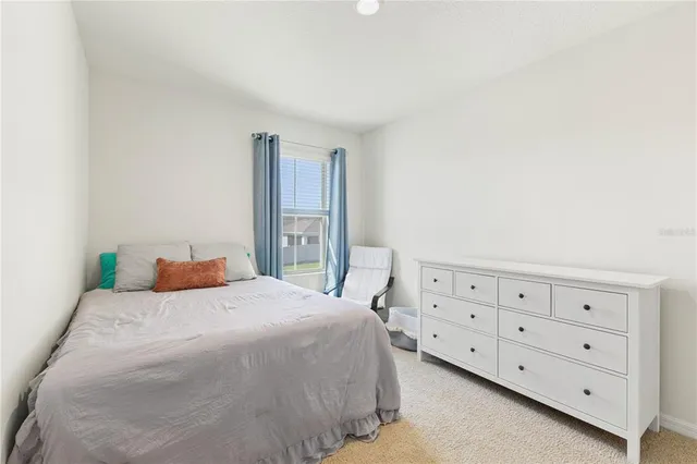 a bedroom with a bed and a bathroom