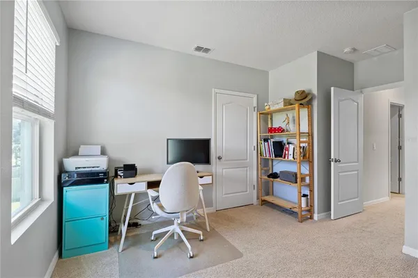 a bedroom with a large bed and a large mirror
