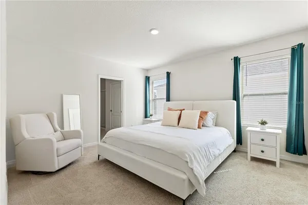 a bedroom with a bed and a couch