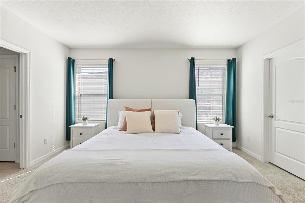 3090 Timber Hawk Circle Ocoee, FL 34761 - Photo 34 of 54 a bedroom with a large bed and a large mirror