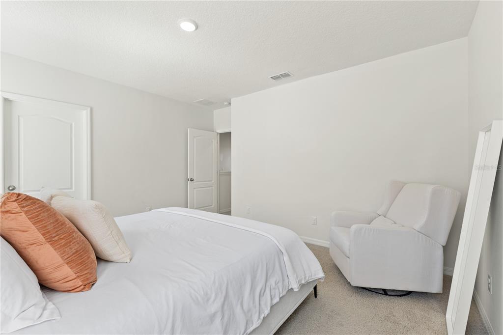 3090 Timber Hawk Circle Ocoee, FL 34761 - Photo 35 of 54 a bedroom with a bed and a couch