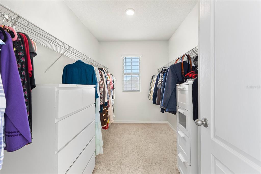 3090 Timber Hawk Circle Ocoee, FL 34761 - Photo 36 of 54 a view of walk in closet with clothes and shoes