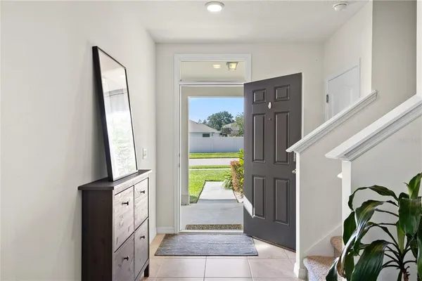 a hallway with painting of the potted plant