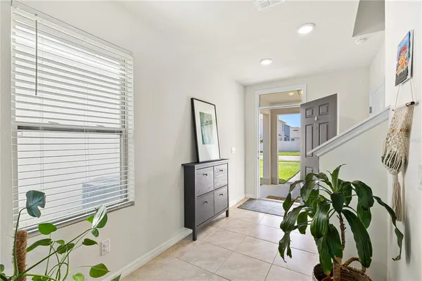 a kitchen with a stove a sink a counter top space and living room