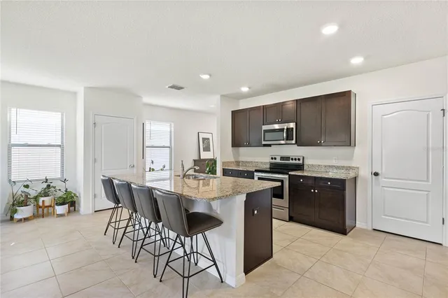 a kitchen with granite countertop a sink and appliances