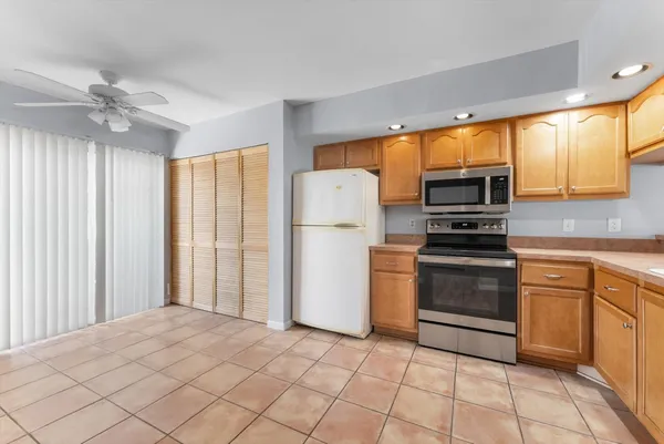 a kitchen with stainless steel appliances a refrigerator sink and cabinets