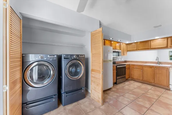 a kitchen with a stove top oven sink and cabinets