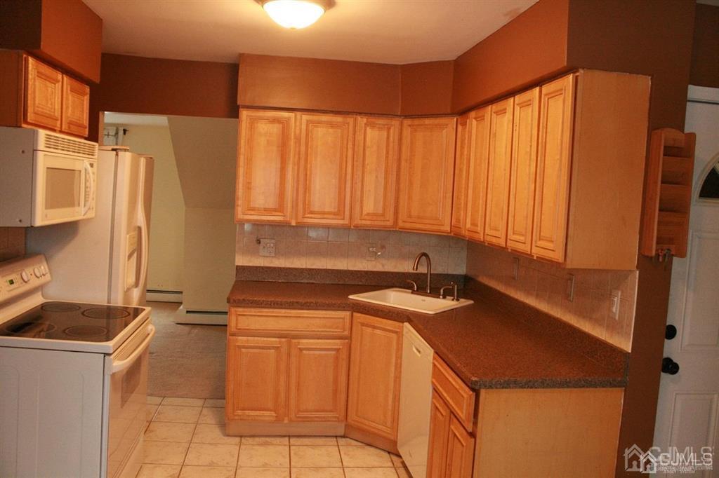 1120 New Dover Road Edison, NJ 08820 - Photo 8 of 9 a kitchen with stainless steel appliances a sink and a refrigerator