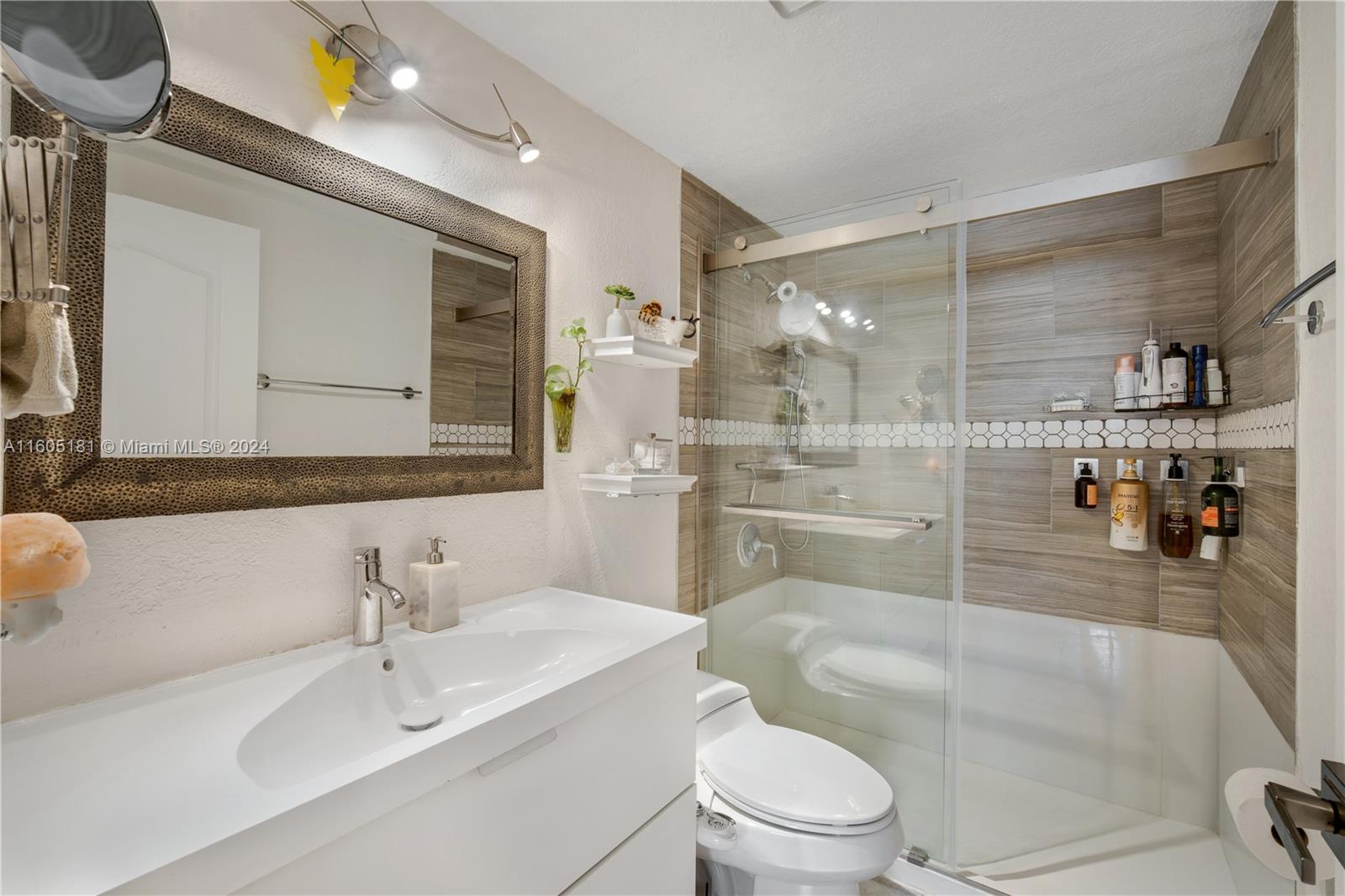677 Northeast 24th Street, Unit 505 Miami, FL 33137 - Photo 13 of 30 a bathroom with a sink a toilet and shower