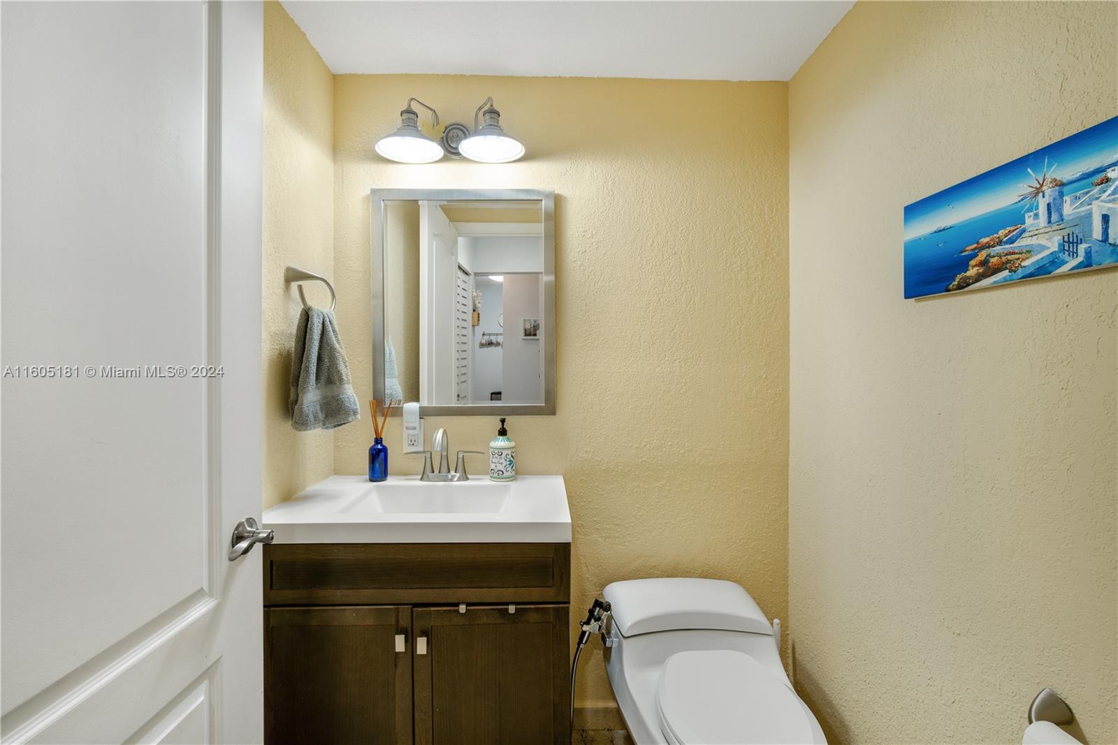 677 Northeast 24th Street, Unit 505 Miami, FL 33137 - Photo 14 of 30 a bathroom with a toilet sink and mirror