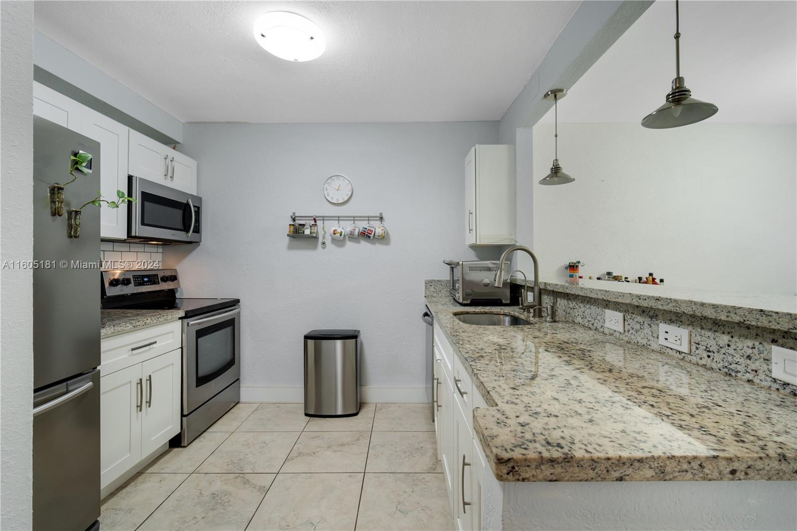 677 Northeast 24th Street, Unit 505 Miami, FL 33137 - Photo 15 of 30 a kitchen with sink cabinets and appliances