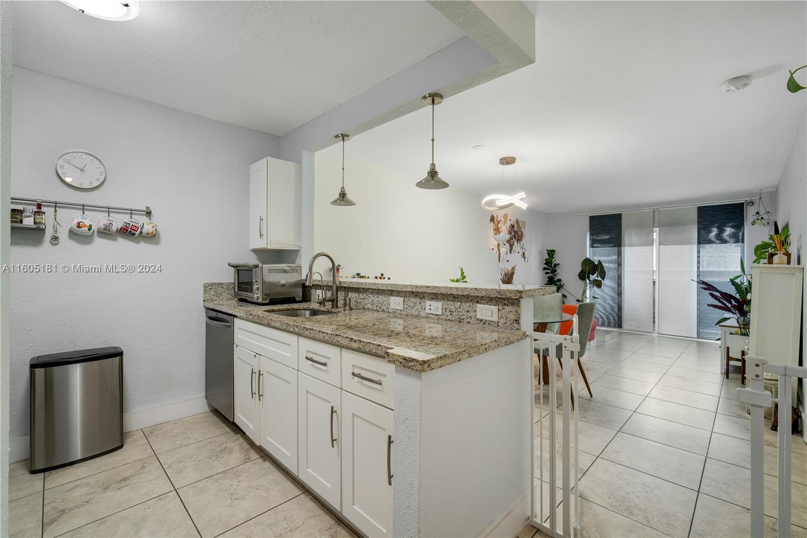 677 Northeast 24th Street, Unit 505 Miami, FL 33137 - Photo 16 of 30 a kitchen with stainless steel appliances granite countertop a sink stove and cabinets