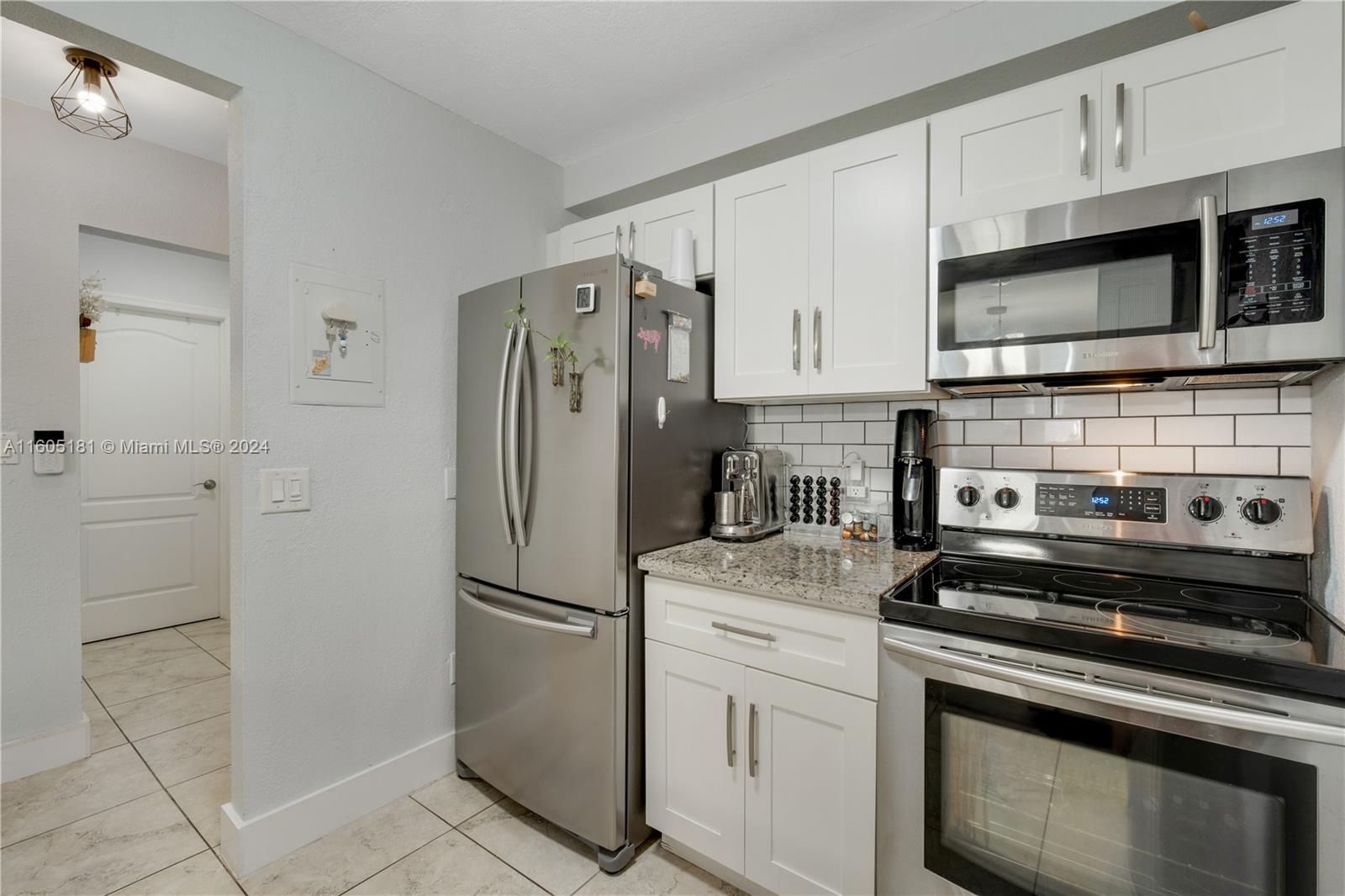 677 Northeast 24th Street, Unit 505 Miami, FL 33137 - Photo 17 of 30 a kitchen with cabinets stainless steel appliances and a counter space