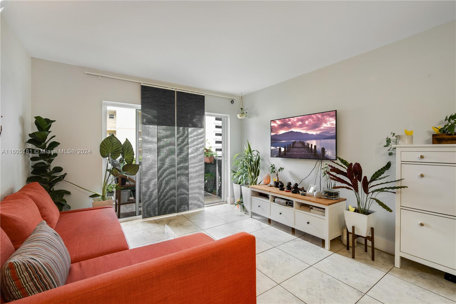 677 Northeast 24th Street, Unit 505 Miami, FL 33137 - Photo 3 of 30 a living room with furniture and a flat screen tv