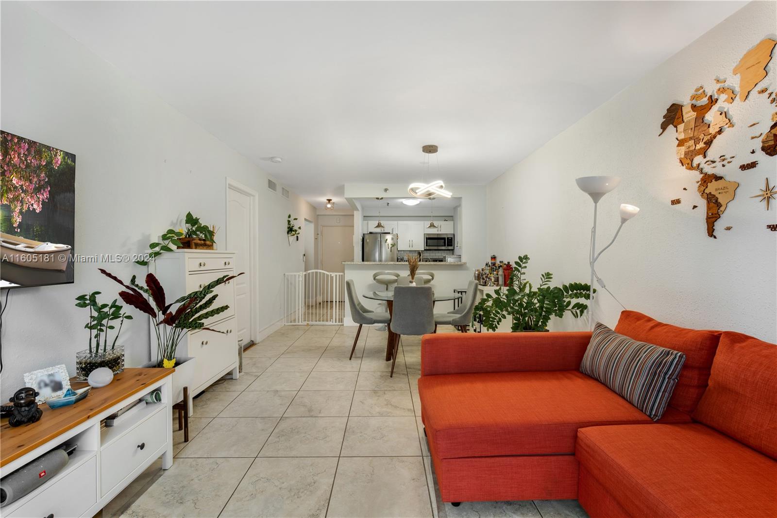 677 Northeast 24th Street, Unit 505 Miami, FL 33137 - Photo 4 of 30 a living room with furniture kitchen view and a potted plant