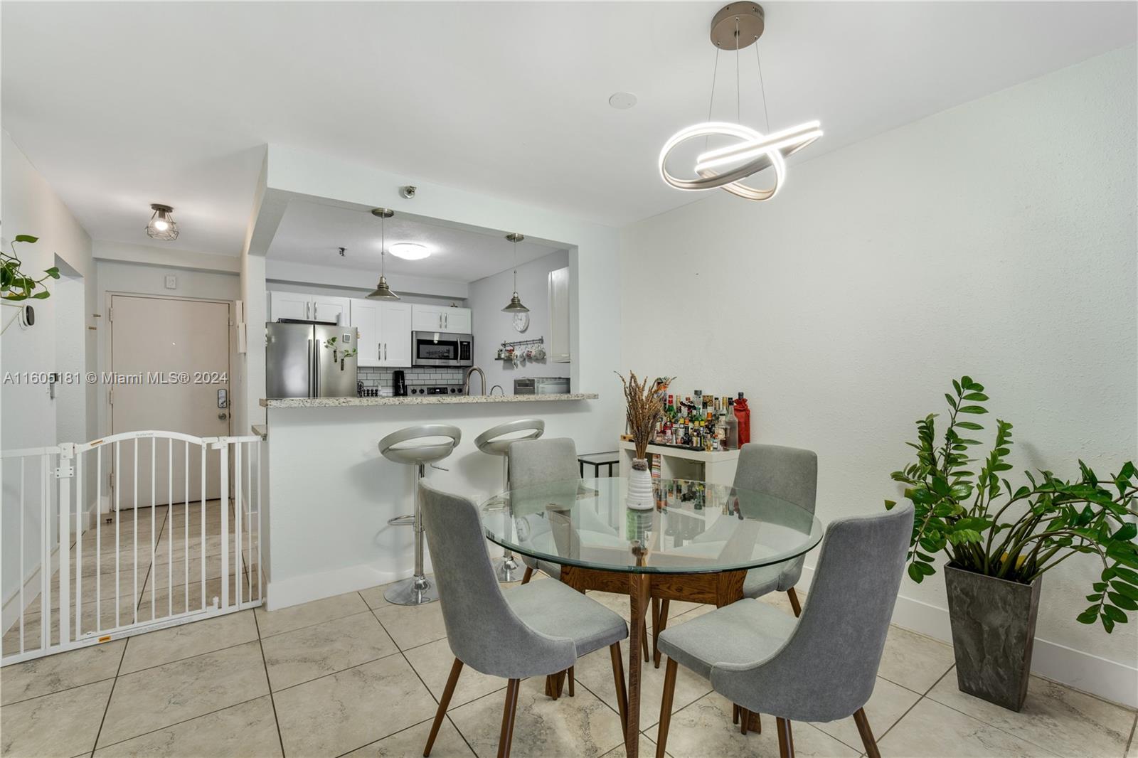 677 Northeast 24th Street, Unit 505 Miami, FL 33137 - Photo 5 of 30 a dining room with furniture and a chandelier