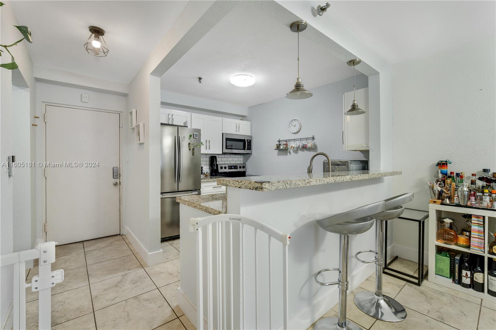 677 Northeast 24th Street, Unit 505 Miami, FL 33137 - Photo 7 of 30 a kitchen with stainless steel appliances a sink cabinets and refrigerator