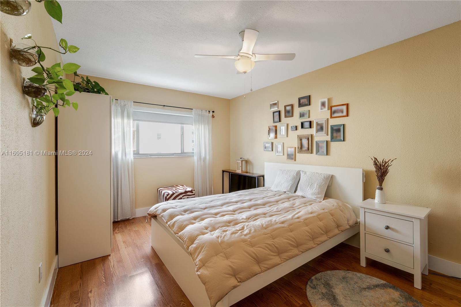 677 Northeast 24th Street, Unit 505 Miami, FL 33137 - Photo 9 of 30 a bedroom with a bed and a chandelier