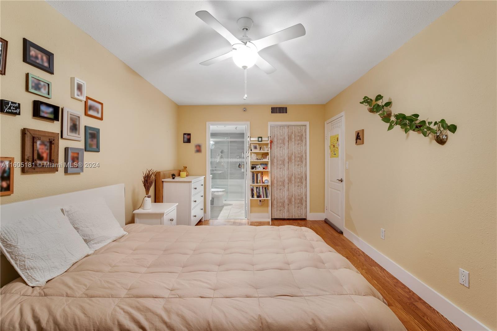 677 Northeast 24th Street, Unit 505 Miami, FL 33137 - Photo 10 of 30 a spacious bedroom with a large bed and a chandelier