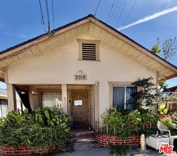 a view of a house with potted plants