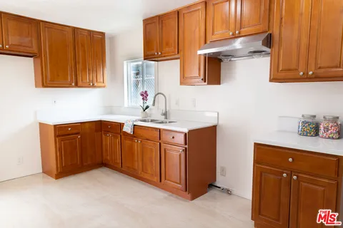 a kitchen with stainless steel appliances granite countertop a sink and cabinets