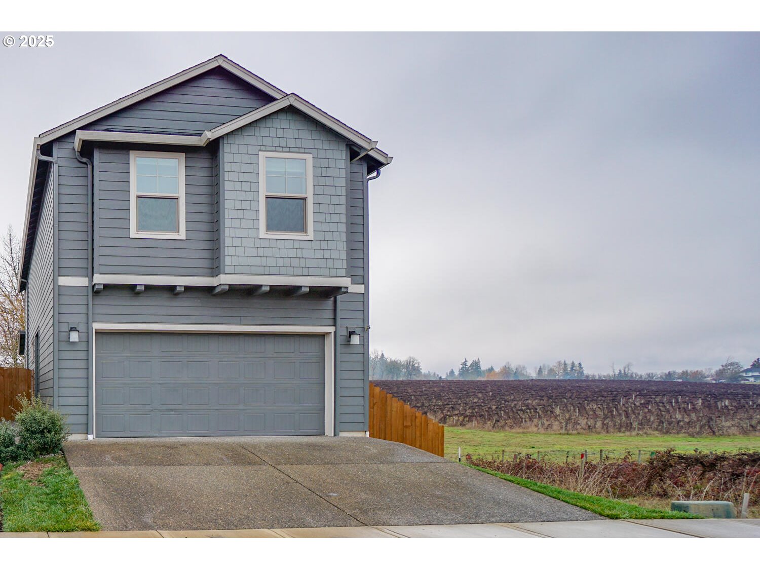 a view of a house with a yard and a garage
