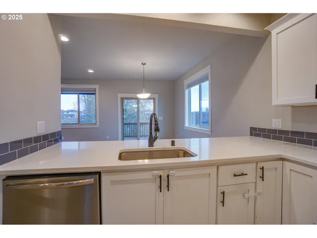 a kitchen with stainless steel appliances granite countertop a sink and a stove