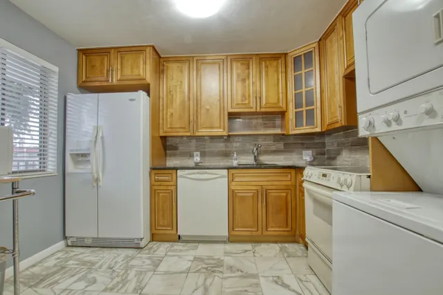 a kitchen with stainless steel appliances granite countertop a refrigerator sink and cabinets