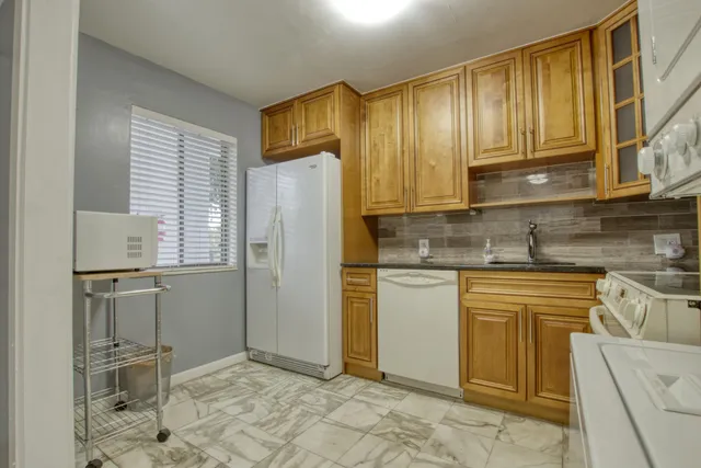 a kitchen with stainless steel appliances granite countertop a refrigerator sink and cabinets