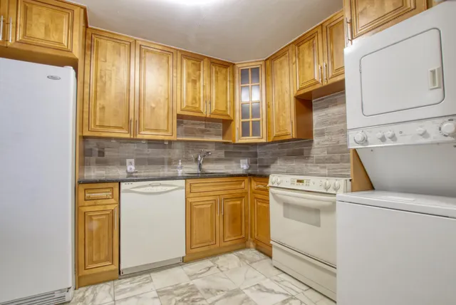 a kitchen with cabinets appliances and a window