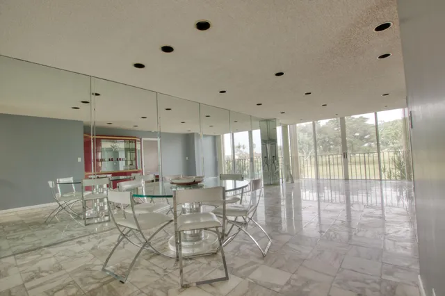 a room with lots of chairs and mirrors