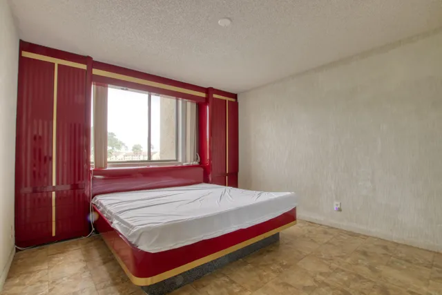 a bedroom with a bed and window